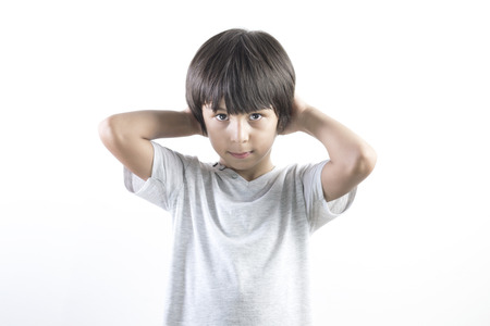 Portrait of thinking little boy over white backgroundの写真素材