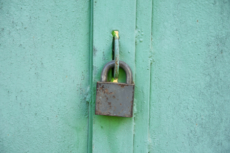 Padlocks are portable locks with a shackle that can be passed through an opening (such as a chain link, or hasp staple) to prevent use, theft, vandalism or harm.の写真素材