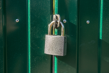 Padlocks are portable locks with a shackle that can be passed through an opening (such as a chain link, or hasp staple) to prevent use, theft, vandalism or harm.の写真素材
