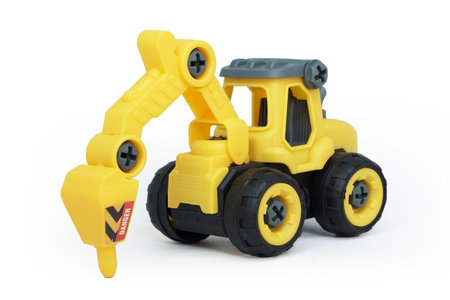 yellow plastic tractor drill toy isolated on white background. heavy construction vehicle.の写真素材