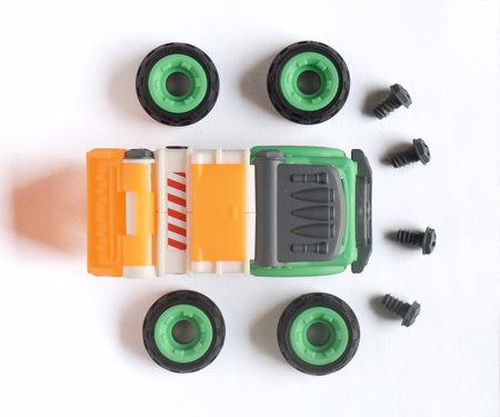 Top view of plastic garbage truck toy with bolt and screwdriver isolated on white background, DIY assemble toy for increasing kid's creativity.の写真素材