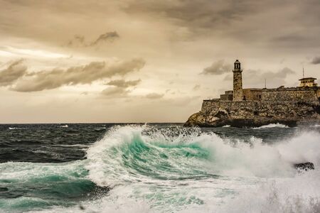 Stormy weather at Havana, Cuba, with big waves and at Morro castle on the backgroundのeditorial素材