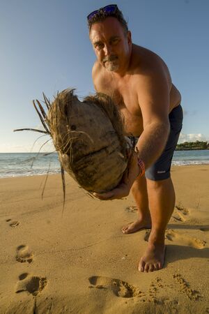 PUNTA CANA, DOMINICAN REPUBLIC - Nov. 8, 2017 A man is offering a coconut on the beach of Punta Cana, In the Dominican Republicのeditorial素材