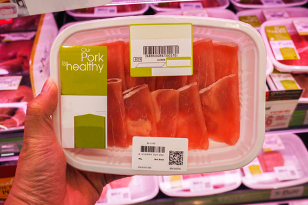 BANGKOK, THAILAND - April 1, 2017: The decision to variety of pork slices packed in boxes in fridge in supermarketのeditorial素材