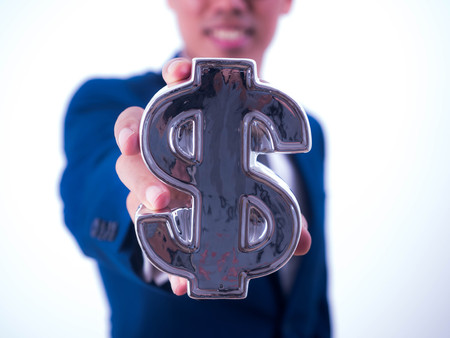 Young businessman Hold a financial symbol isolated on white background.の写真素材