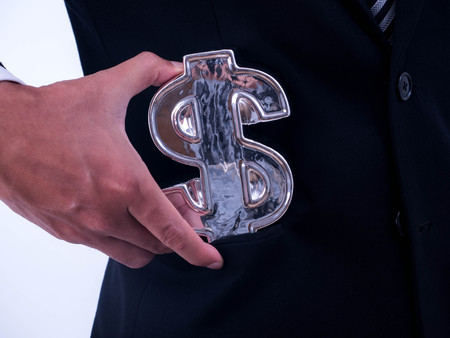 Young businessman Hold a financial 
symbol in a suit pocket.の写真素材