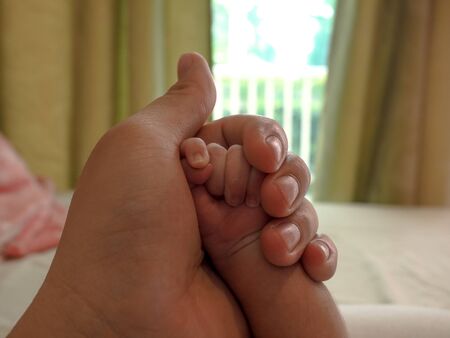 close-up hand baby in the hand of mother. happy familyの写真素材