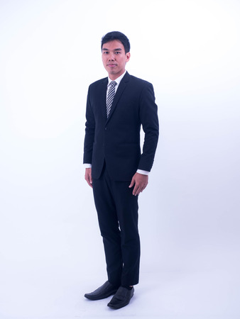 Full length portrait of a young asian businessman standing.の写真素材