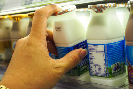 BANGKOK THAILAND - April 7, 2017: The decision to buy  milk in Super Market.のeditorial素材