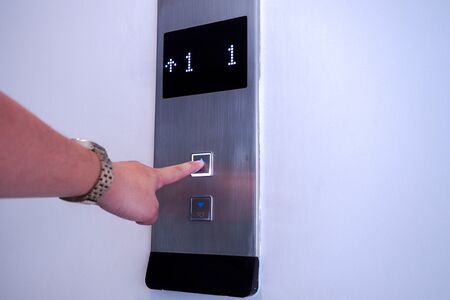 Use finger to press the elevator button.