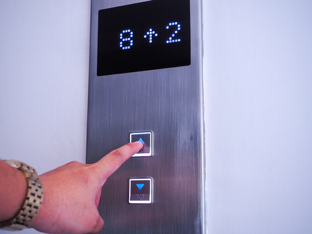 Use finger to press the elevator button.