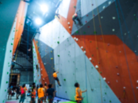 Blurred image  Attractive of many people climbing up the wall in gymの写真素材