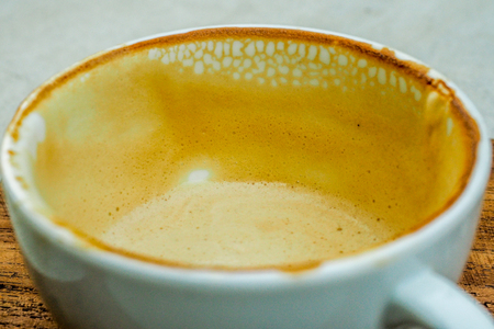 empty cup of hot coffee with coffee mark in the white coffee cup on the saucer with coffeeの写真素材