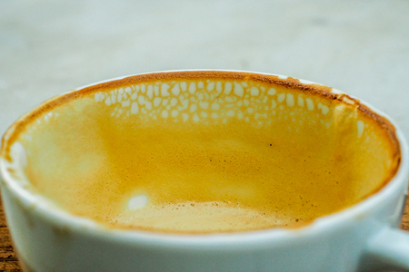 empty cup of hot coffee with coffee mark in the white coffee cup on the saucer with coffeeの写真素材
