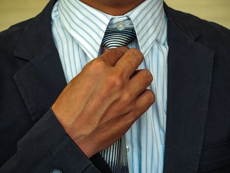 Business Man fixing his suitの写真素材