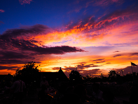 Family holiday, sit and eat together Outside restaurant at sunsetの写真素材