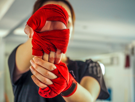 teenage girl in sports clothes holding a dislocated shoulder on trainingの写真素材