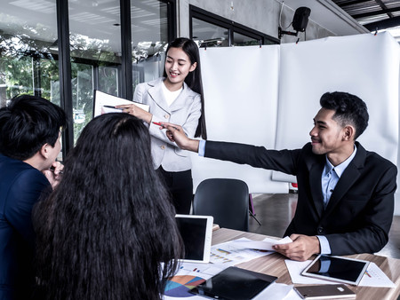 sharing ideas of business team using pen with financial diagram and digital tabletの写真素材