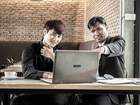Two attractive business man having a meeting while having coffee in a coffee shop's .の写真素材