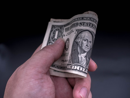 Men's hand holding bank dollar. Concept of giving