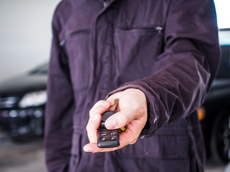 man handing a car key