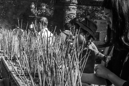 Black and white tone Yellow Buddhist prayer sticks burning in the censer at Po Lin Monastery, Lantau Island, Hong Kongのeditorial素材