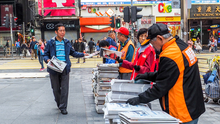 HONGKONG, CHINA - December 9 2016: Distribution of the  free newspaper on the road with every morning in Hong Kong.のeditorial素材