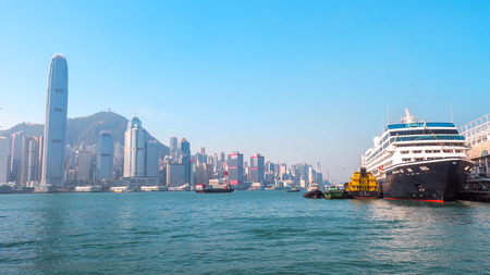 Cruise ship dock embarkment Port Ocean Terminal in Victoria Harbour and Hong Kong Skyline Cityscape at sunrise from Tsim Sha Tsuiのeditorial素材