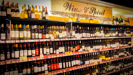 Hong Kong - DEC 11,2016: Wine shelves with price tags on display at store wine & spirit in Hong Kong, Defocused rows of Wine Liquor bottles on the supermarket shelf.のeditorial素材