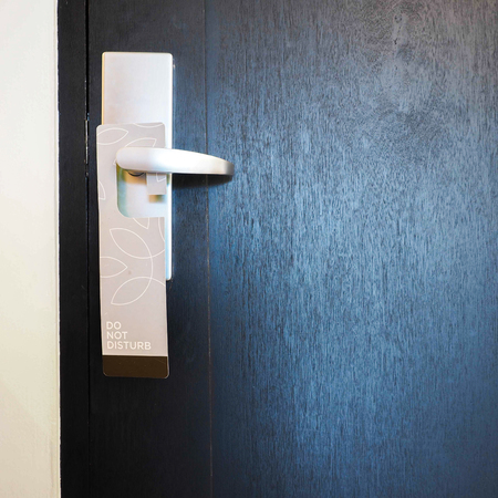 Please do not disturb wooden hanger, hanging on a handle of wooden door of home or hotelの写真素材