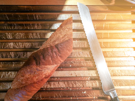 Long Bread with Knife on Wooden Tray