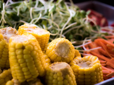Corn, carrots and sunflower seedlings Prepared to eat.の写真素材