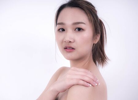 Beautiful Young asian girl with Clean Fresh Skin touch own face, Cosmetology, beauty and spa, Gentle skinの写真素材