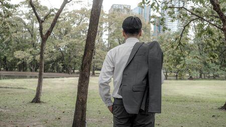 Businessmen standing back in the park.の写真素材