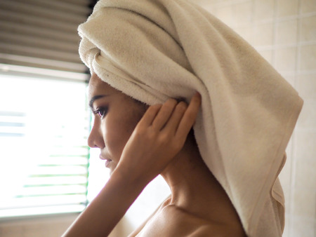 Sexy girl standing in bathroom with warm sunshine