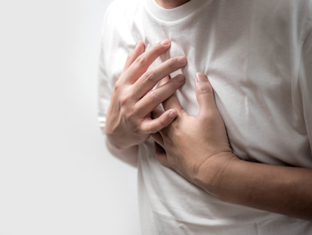 Man suffering from chest pain on white background, Health care