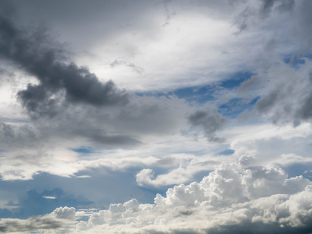Dark blue grey layered clouds sky cover sun before raining.