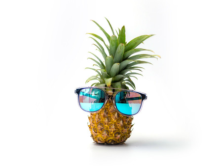 Ripe pineapple with sunglasses isolated on white background, Summer concept.の写真素材