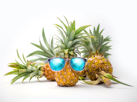 Ripe pineapple with sunglasses isolated on white background, Summer concept.の写真素材