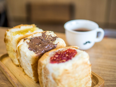 Sweet chocolate cream bread stuffed and coffee on the table