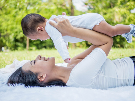 Happy family, Mother and baby happy and playing in the summer on the nature backgroundの写真素材