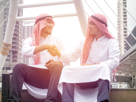 Concept of partnership - Arab business partners team shaking hands for business successの写真素材