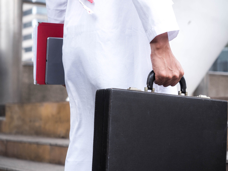Arab businessman holding file and business bag with free copy space.の写真素材