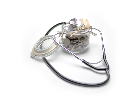Coins in Glass Jar and stethoscope, Listening to Saving money conceptの写真素材