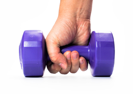 Man's hand holding violet dumbbell isolated on white background. Close up. Concept of healthy lifestyleの写真素材