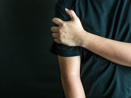 Man holding his painful arm, healthcare and ache in human body