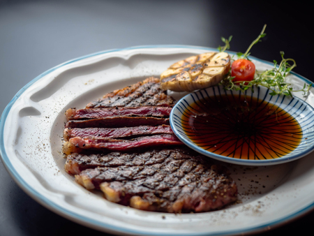 Grilled beef steak with grilled garlic.