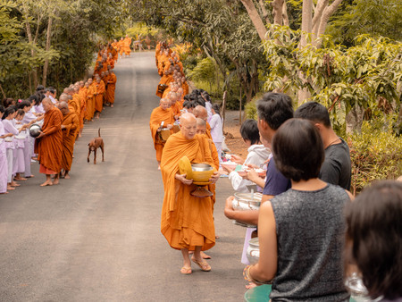 Khao Yai, Thailand - April 23, 2019: Buddhist Monks Line up in Row Waiting for Buddhism People to Give Alms Bowl in Makut Khiriwan Temple.のeditorial素材