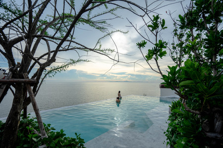 Pattaya, Thailand Luxury - June 3, 2019: swimming pool and blue water at the resort with beautiful sea view at u jomtien pattaya. Seaside poolのeditorial素材