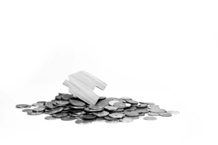 House model on coin pile saving for concept with isolated on white background.Concept for property,...